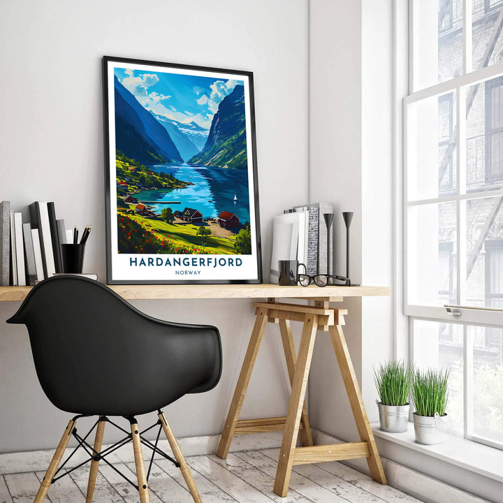 Colorful Scandinavian travel poster of Hardangerfjord in Norway highlighting a coastal hamlet, red wildflowers, and deep blue water reflections. Designed for travel lovers, this wall decor item comes in unframed paper prints, custom wood framed setups, and gallery wrapped canvas options.