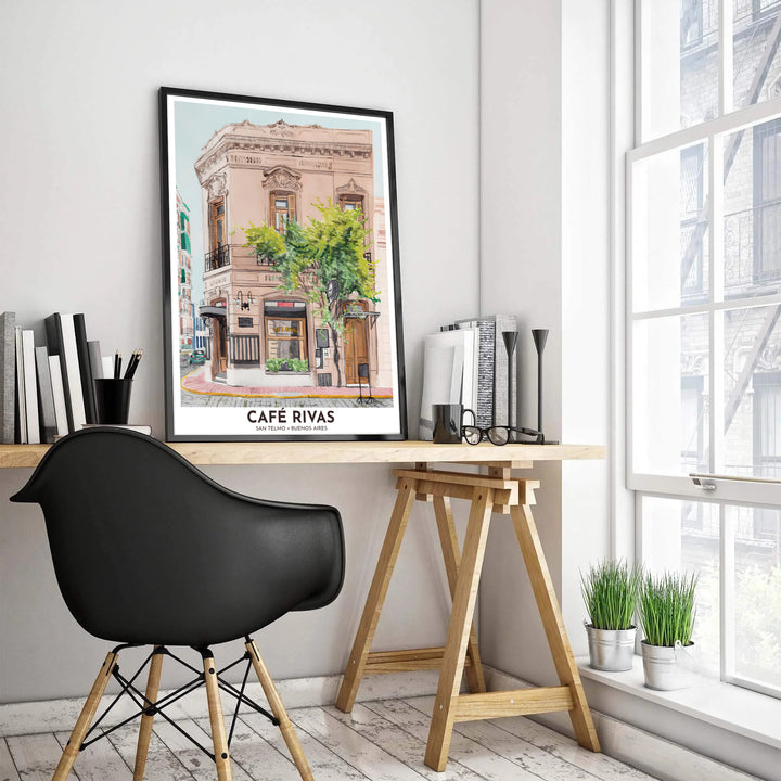 Capturing soft dusty pink building tones and warm wood cafe doors, this San Telmo Cafe Rivas print brings bohemian South American charm into your home, presented by MapYourDreams with selection flexibility across unframed paper, hand-crafted frames, and canvas wraps.