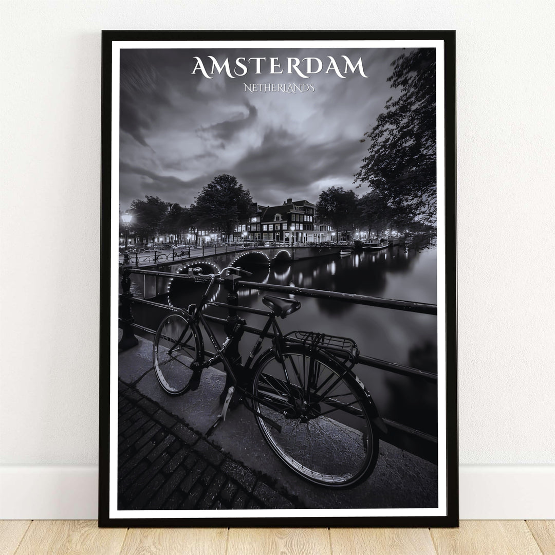 Amsterdam night canal poster showcasing a black and white photography art print with a vintage bicycle on a bridge overlooking illuminated arches, offered by MapYourDreams with product options including unframed paper prints, gallery wrapped canvas wall decor, or custom framed options for moody rooms.