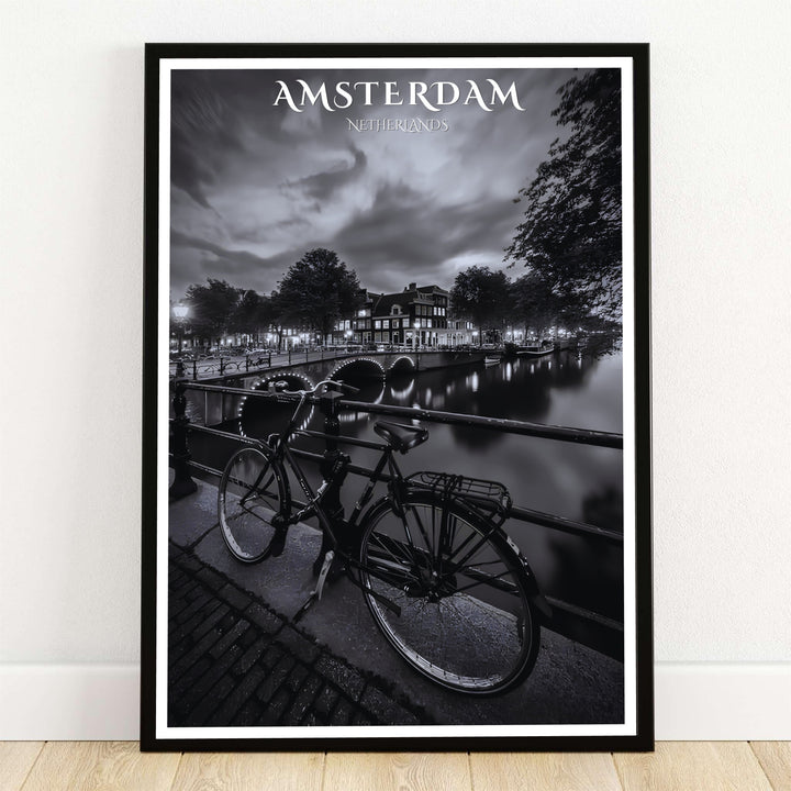 Amsterdam night canal poster showcasing a black and white photography art print with a vintage bicycle on a bridge overlooking illuminated arches, offered by MapYourDreams with product options including unframed paper prints, gallery wrapped canvas wall decor, or custom framed options for moody rooms.