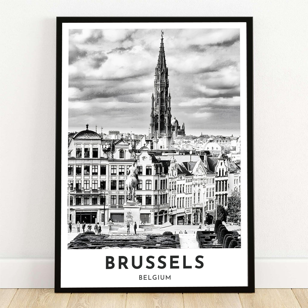 A dramatic black and white photography print showing the elevated view from Mont des Arts over the Gothic Town Hall spire in Brussels, Belgium. Offered by MapYourDreams, this artwork is available in flexible options including unframed paper, custom wooden frames, and gallery canvas wraps.