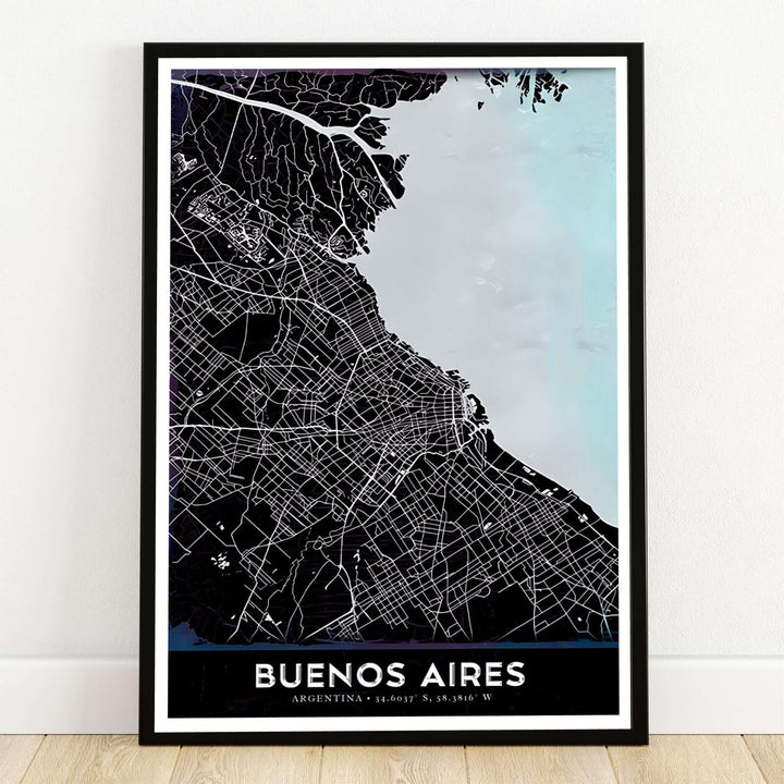 Buenos Aires black and icy blue map poster print displaying the detailed city street grid in white against dark land and light blue water with coordinates. Crafted by MapYourDreams, this design can be ordered as borderless archival paper, custom wooden frames, or gallery canvas wraps.