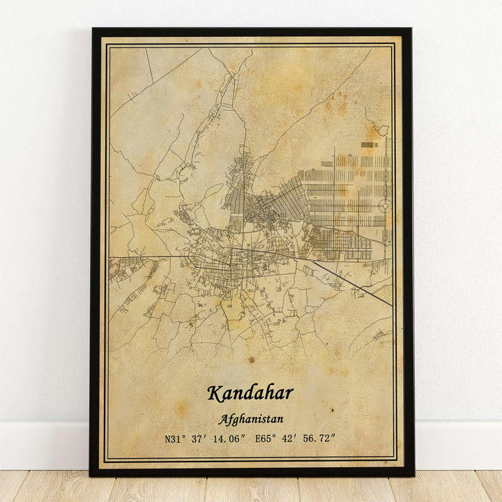 Antique cartography wall poster showcasing the city street grid and roads of Kandahar, Afghanistan, printed on an aged sepia parchment background with geographic coordinates. MapYourDreams supplies this map artwork as an unframed art print, a stretched canvas display, or a sleek black framed poster for modern offices.