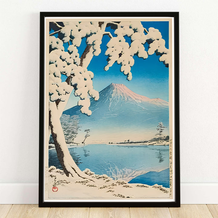 Kawase Hasui Lake Kawaguchi 1932 Japanese landscape print of Lake Kawaguchi by artist Kawase Hasui displaying Mount Fuji covered in snow with heavy pine branches framing Lake Kawaguchi. MapYourDreams offers framed, unframed paper, and canvas wall art options.
