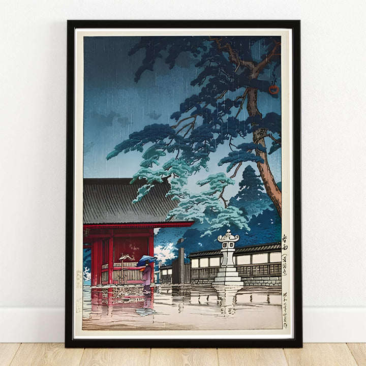 Japanese historic travel print Spring Rain Gokokuji Temple with traditional blue umbrella by artist Kawase Hasui inspired by atmospheric rain at Spring Rain Gokokuji Temple. MapYourDreams offers versatile framed, unframed, and canvas print wall decor formats.