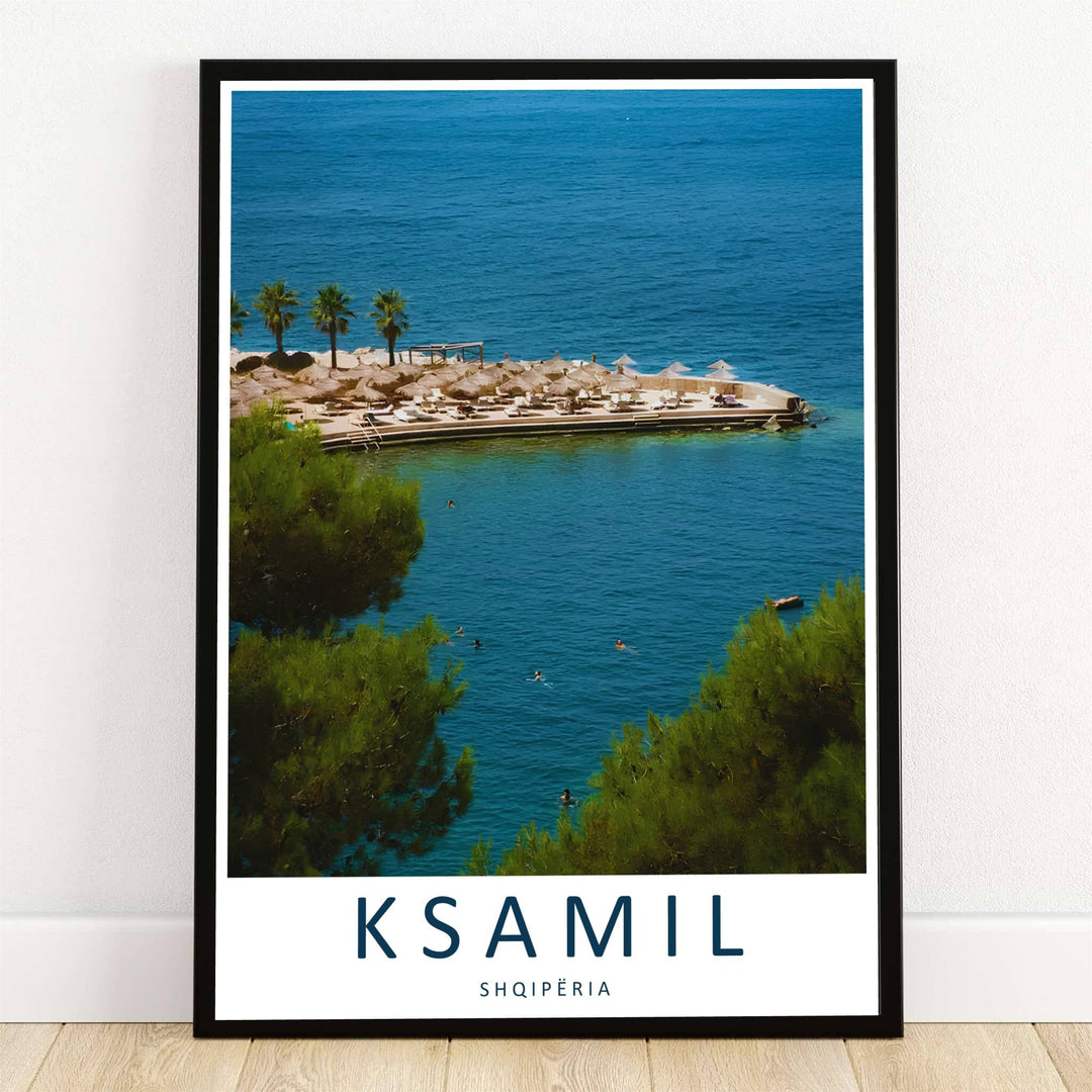 Lush green pine tree branches frame an elevated view of Ksamil Beach, Albania, where thatched umbrellas line a sunlit pier over azure waters. Offered by MapYourDreams, this artwork is available in flexible options including unframed paper, custom wooden frames, and gallery canvas wraps.