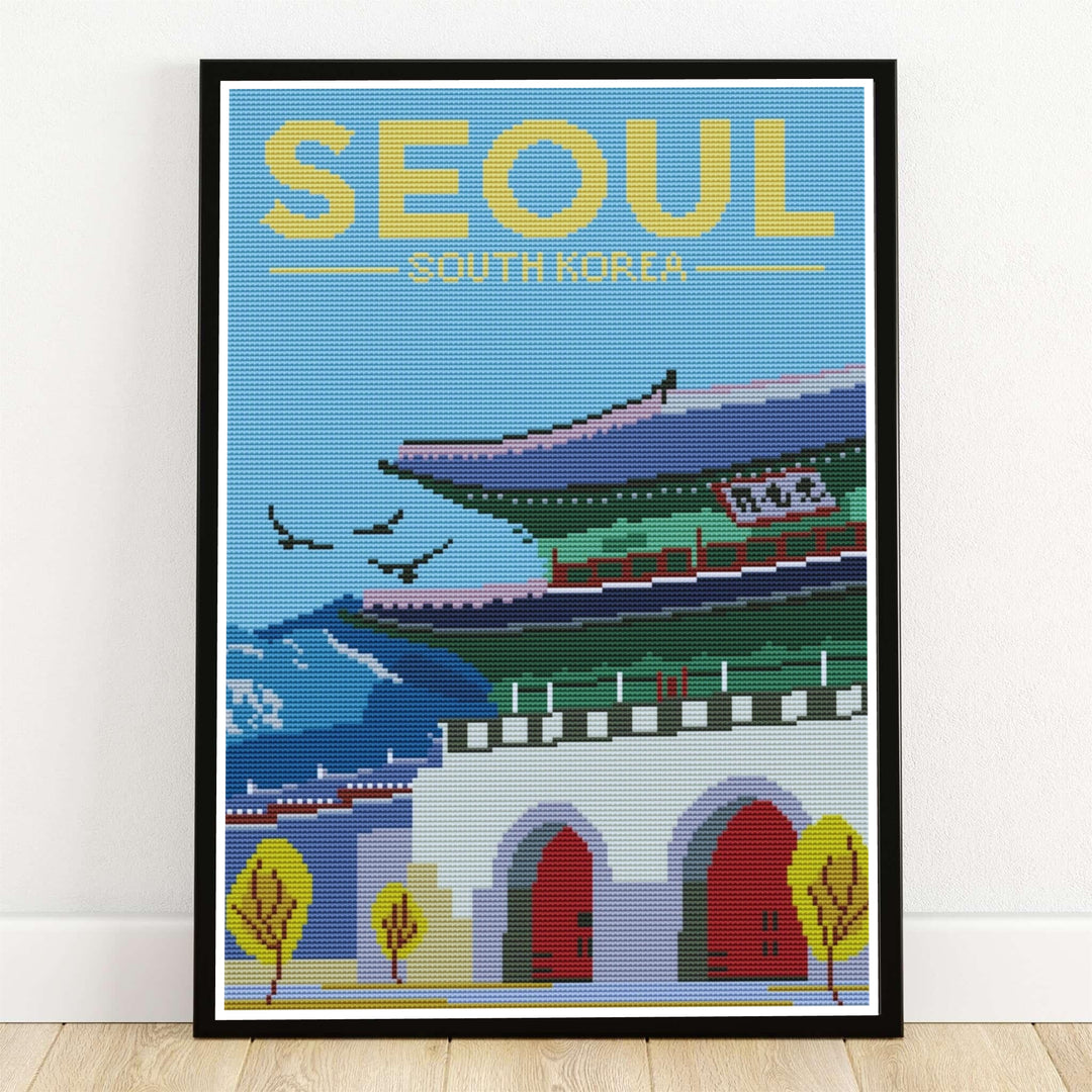 Textured cross-stitch tapestry travel art print depicting the grand Gwanghwamun Gate in Seoul, South Korea, with arched stone doorways, red wooden gates, jade green eaves, yellow autumn trees, and soaring birds. Offered by MapYourDreams, this artwork is available in flexible options including unframed paper, custom wooden frames, and gallery canvas wraps.