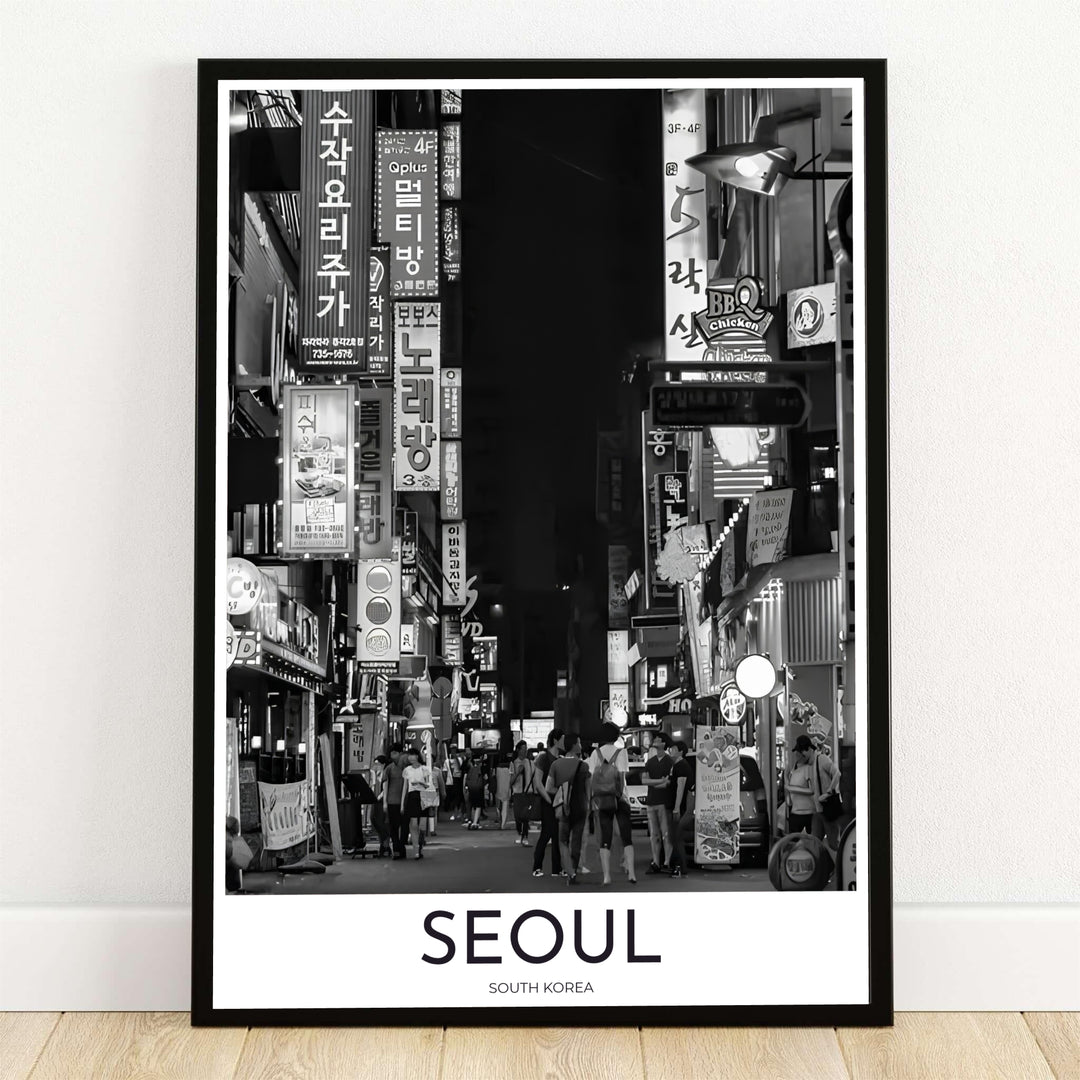 Monochromatic black and white photography print showing a bustling night alley street in Seoul South Korea with glowing Hangul signs, offered by MapYourDreams in flexible options including unframed paper, custom wooden frames, and gallery canvas wraps to elevate your living room wall decor.