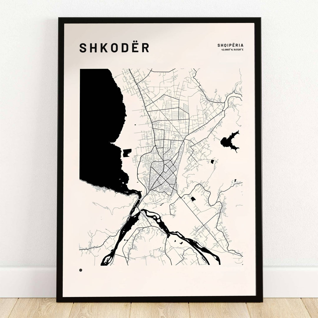 Bold solid black water shapes outline Lake Shkodër alongside fine street linework on a warm off-white map poster. Offered by MapYourDreams, this artwork is available in flexible options including unframed paper, custom wooden frames, and gallery canvas wraps.