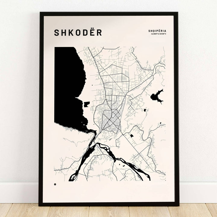 Bold solid black water shapes outline Lake Shkodër alongside fine street linework on a warm off-white map poster. Offered by MapYourDreams, this artwork is available in flexible options including unframed paper, custom wooden frames, and gallery canvas wraps.