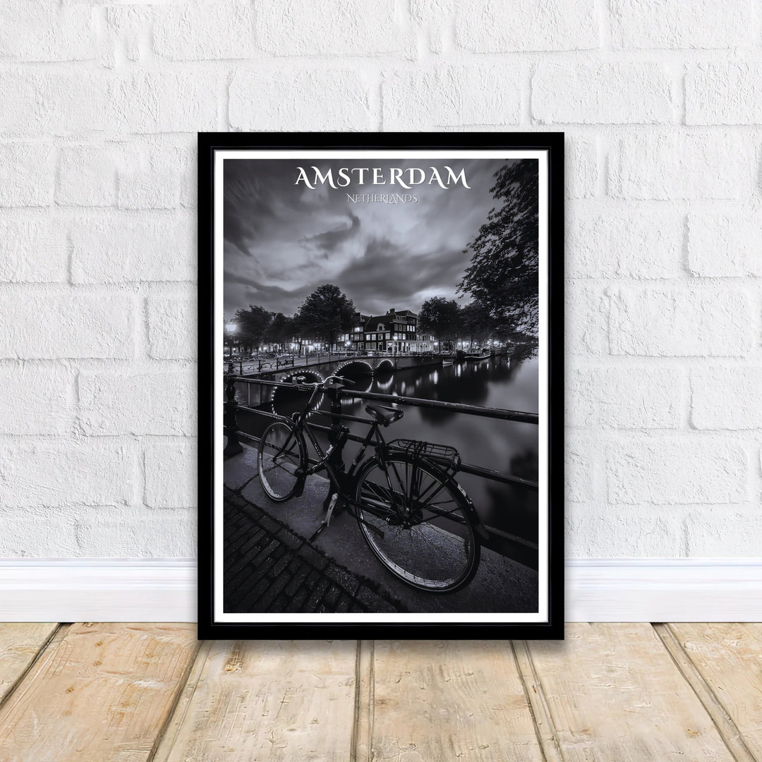 Moody black and white European cityscape wall art featuring dark canal waters and glowing bridge lights in Amsterdam, offered by MapYourDreams where options include unframed paper prints, gallery wrapped canvas decor, or custom frame styling designed to enhance minimalist interior layouts.
