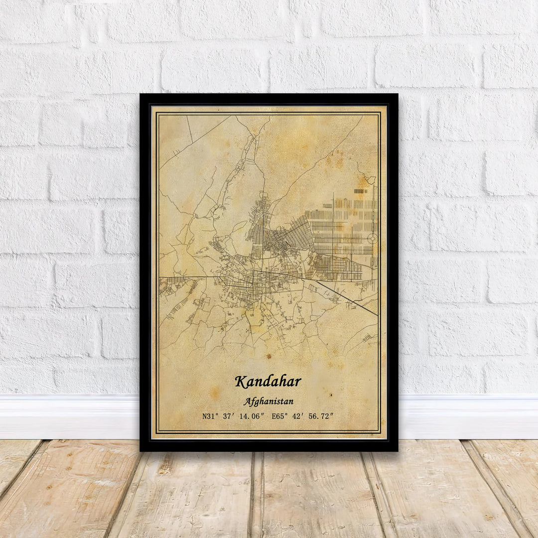 Aged parchment map art print highlighting the historic road network and geographic coordinate markings of Kandahar, Afghanistan. Available from MapYourDreams as an unframed fine art poster, a stretched gallery canvas, or a custom framed decor piece in classic black and natural wood frame styles.