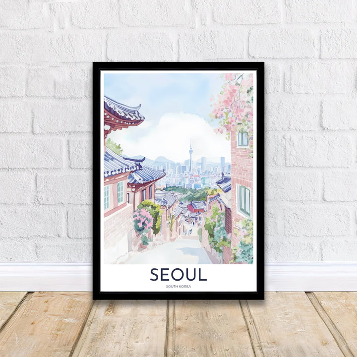 Elegant watercolor travel poster of Seoul, South Korea, presenting a narrow village lane leading downhill toward the misty blue skyline and N Seoul Tower surrounded by traditional Korean architecture. Offered by MapYourDreams, this artwork is available in flexible options including unframed paper, custom wooden frames, and gallery canvas wraps.