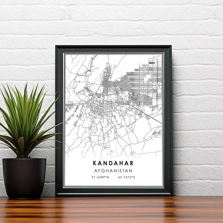 Modern black and white map art print highlighting the road network and geographic coordinate markings of Kandahar, Afghanistan. Available from MapYourDreams as an unframed fine art poster, a stretched gallery canvas, or a custom framed decor piece in classic black and natural wood frame styles.