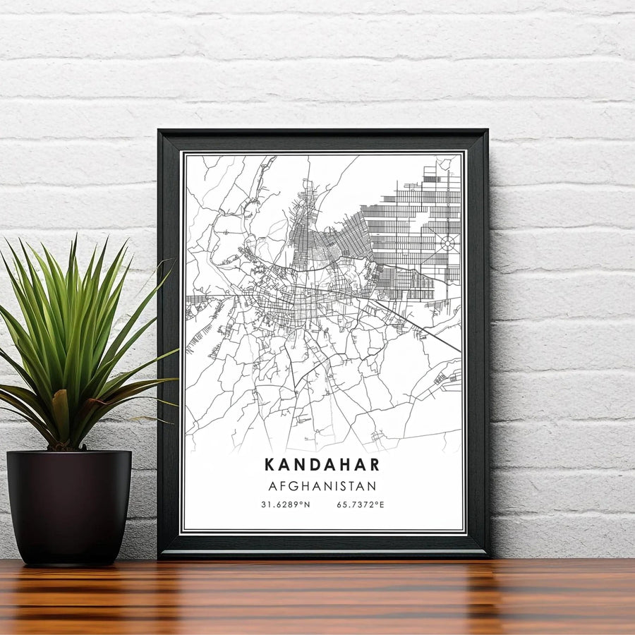 Modern black and white map art print highlighting the road network and geographic coordinate markings of Kandahar, Afghanistan. Available from MapYourDreams as an unframed fine art poster, a stretched gallery canvas, or a custom framed decor piece in classic black and natural wood frame styles.