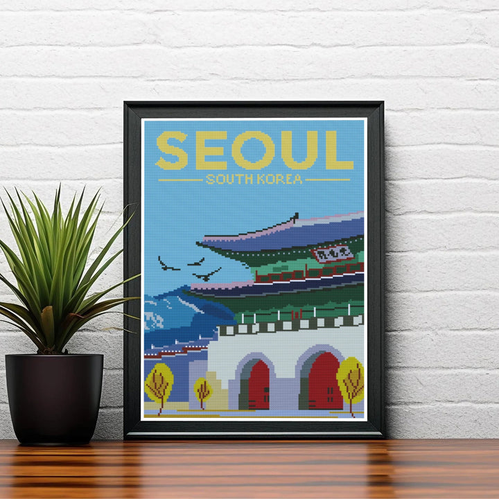 Aesthetic Korean cross-stitch poster illustrating historic Joseon dynasty architecture at Gwanghwamun Gate in Seoul, South Korea, with sweeping tiled rooflines and flying bird silhouettes. Offered by MapYourDreams, this artwork is available in flexible options including unframed paper, custom wooden frames, and gallery canvas wraps.
