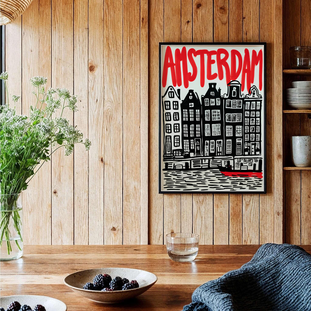 Modernist block print cityscape poster of Amsterdam canal houses and hand-lettered red title, provided by MapYourDreams in versatile choices including unframed paper, gallery wrapped canvas, or custom frame configurations in retro black, pure gold, and natural wood for studios.