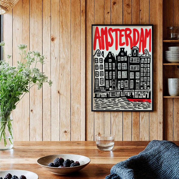 Modernist block print cityscape poster of Amsterdam canal houses and hand-lettered red title, provided by MapYourDreams in versatile choices including unframed paper, gallery wrapped canvas, or custom frame configurations in retro black, pure gold, and natural wood for studios.