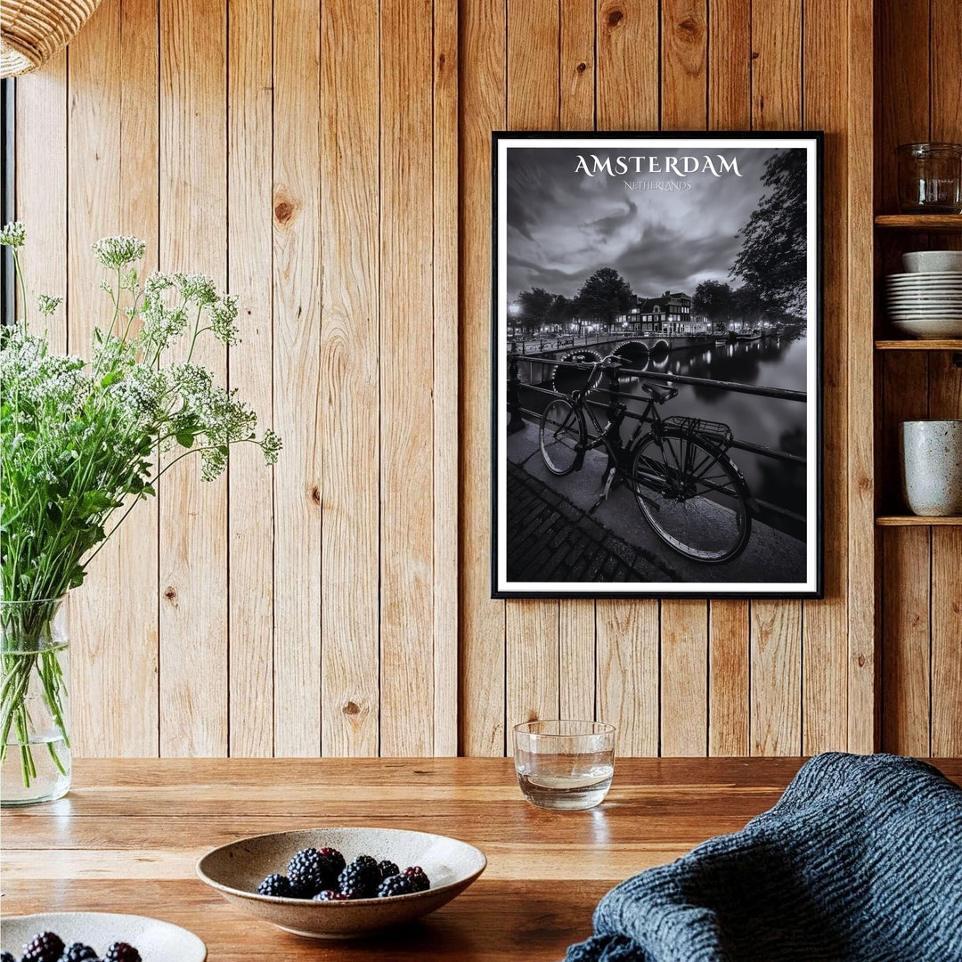 High-contrast black and white city poster of historic Amsterdam canal architecture lit by glowing bridge lamps at night, provided by MapYourDreams with available options like unframed paper prints, gallery canvas, or custom frame finishes in natural wood, pure gold, and bronze for offices.