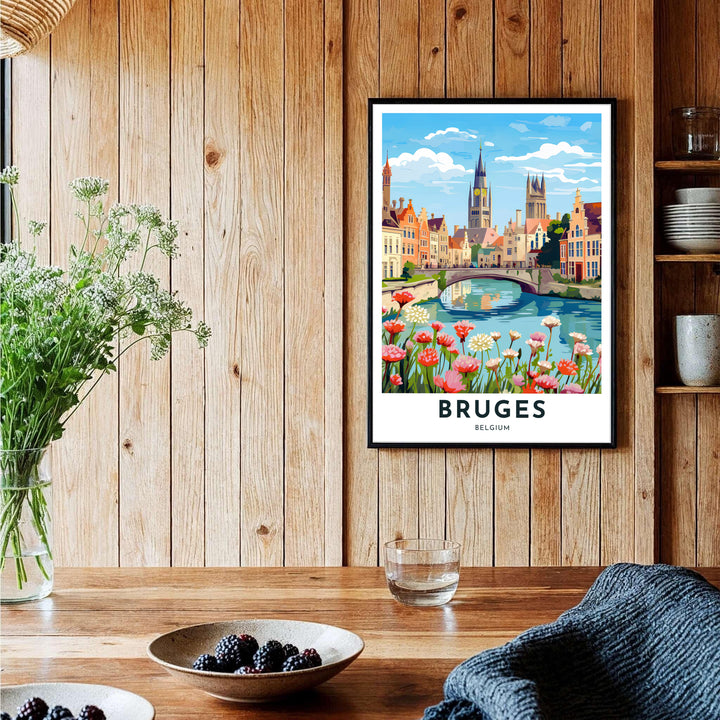 A modern travel poster depicting a flower-lined canal bridge and historic church steeples in Bruges, Belgium, finished with crisp text reading Bruges Belgium. Offered by MapYourDreams, this artwork is available in flexible options including unframed paper, custom wooden frames, and gallery canvas wraps.