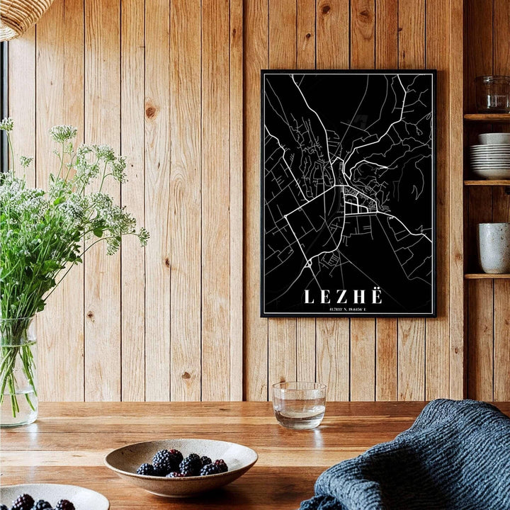 A sophisticated black and white geographical map of Lezhë, Albania, framed by clean borders and sharp serif text at the bottom. Available across multiple formats including unframed paper, tailored wooden frames, and gallery-wrapped canvas options.