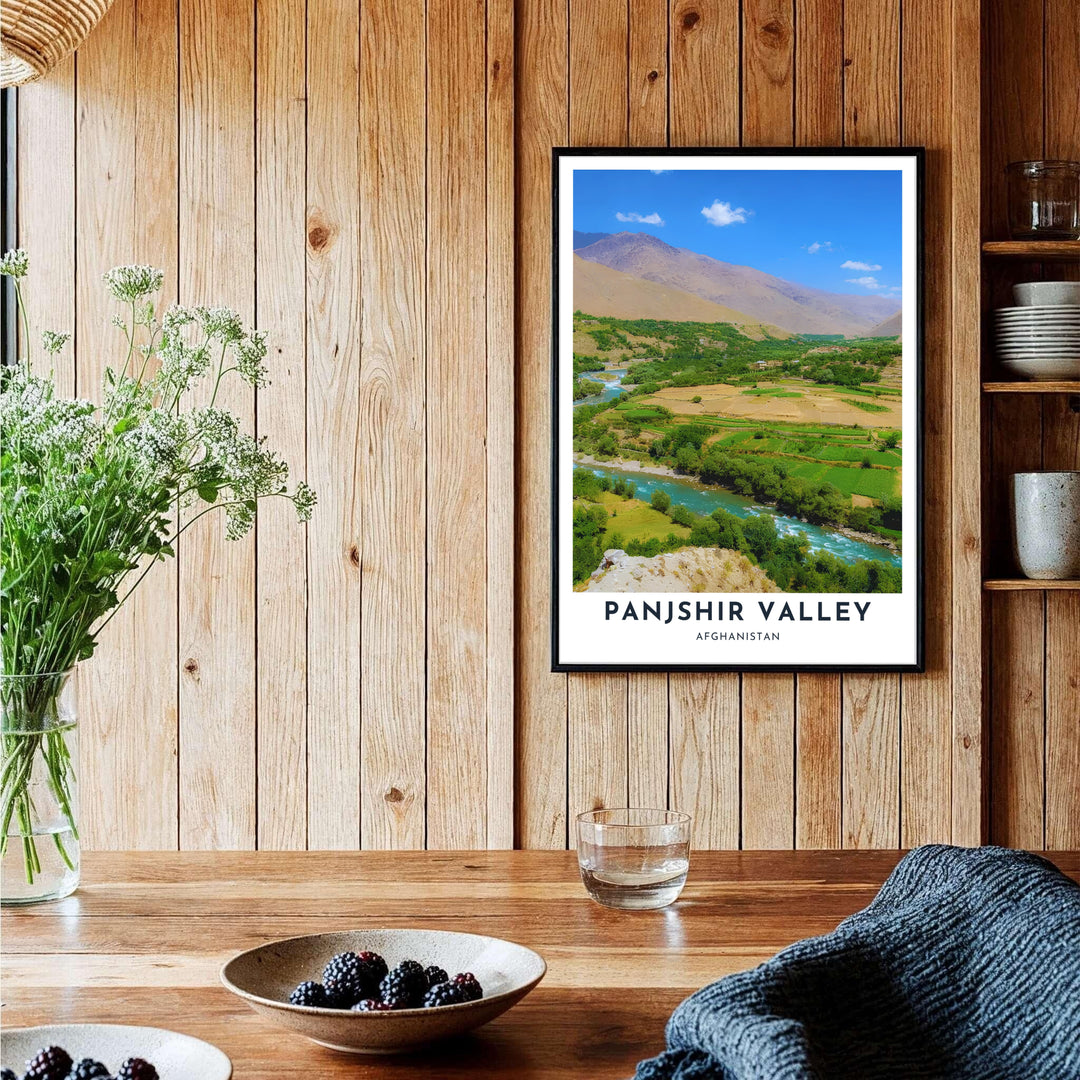 Fine art nature poster displaying the sunlit valley floor and mountain ridges of Panjshir, Afghanistan, bordered by stylish white typography. Provided by MapYourDreams as an unframed print, a stretched canvas wall art piece, or a custom framed print in a pure gold frame for executive study environments.