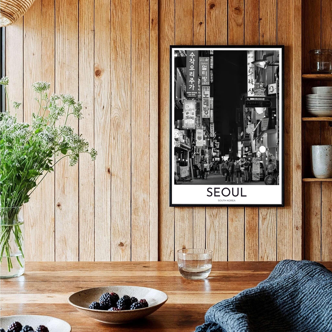 Elegant black and white travel wall art featuring a Seoul night street lined with glowing signs and walking crowds in South Korea, curated by MapYourDreams across unframed archival paper, natural wood frames, and gallery stretched canvas to deliver premium quality print aesthetics.