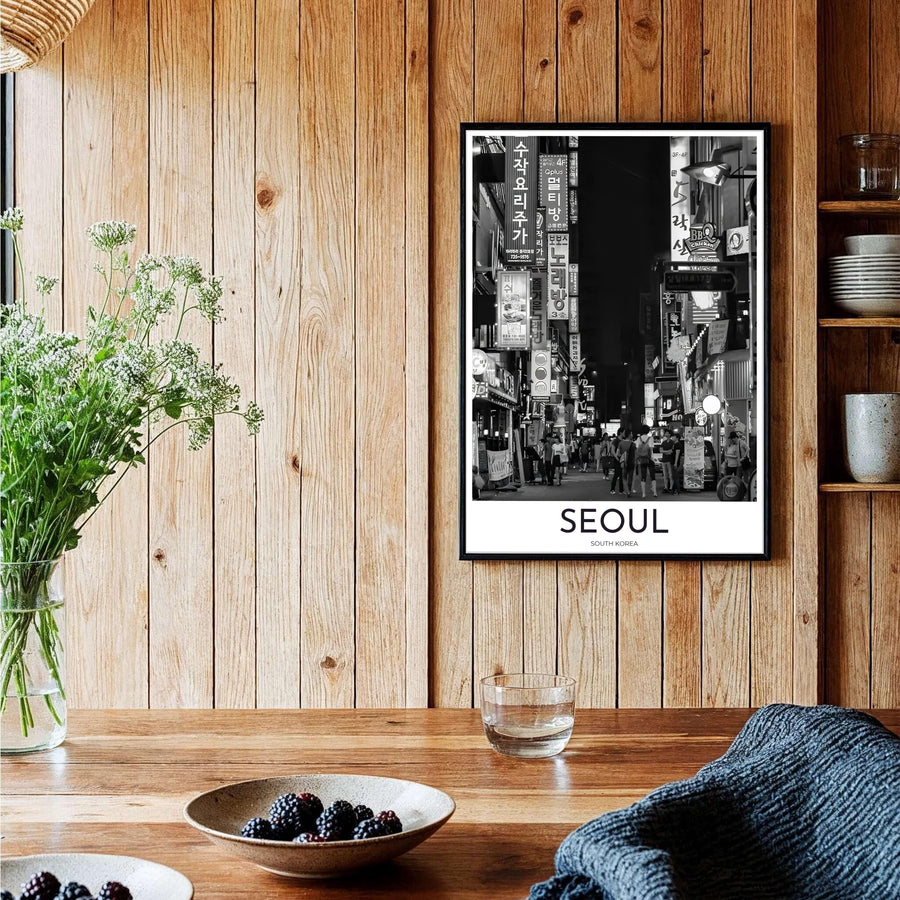 Elegant black and white travel wall art featuring a Seoul night street lined with glowing signs and walking crowds in South Korea, curated by MapYourDreams across unframed archival paper, natural wood frames, and gallery stretched canvas to deliver premium quality print aesthetics.