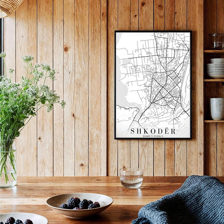 A sophisticated black and white geographical map of Shkodër, Albania, framed by clean borders and sharp serif text at the bottom. Available across multiple formats including unframed paper, tailored wooden frames, and gallery-wrapped canvas options.