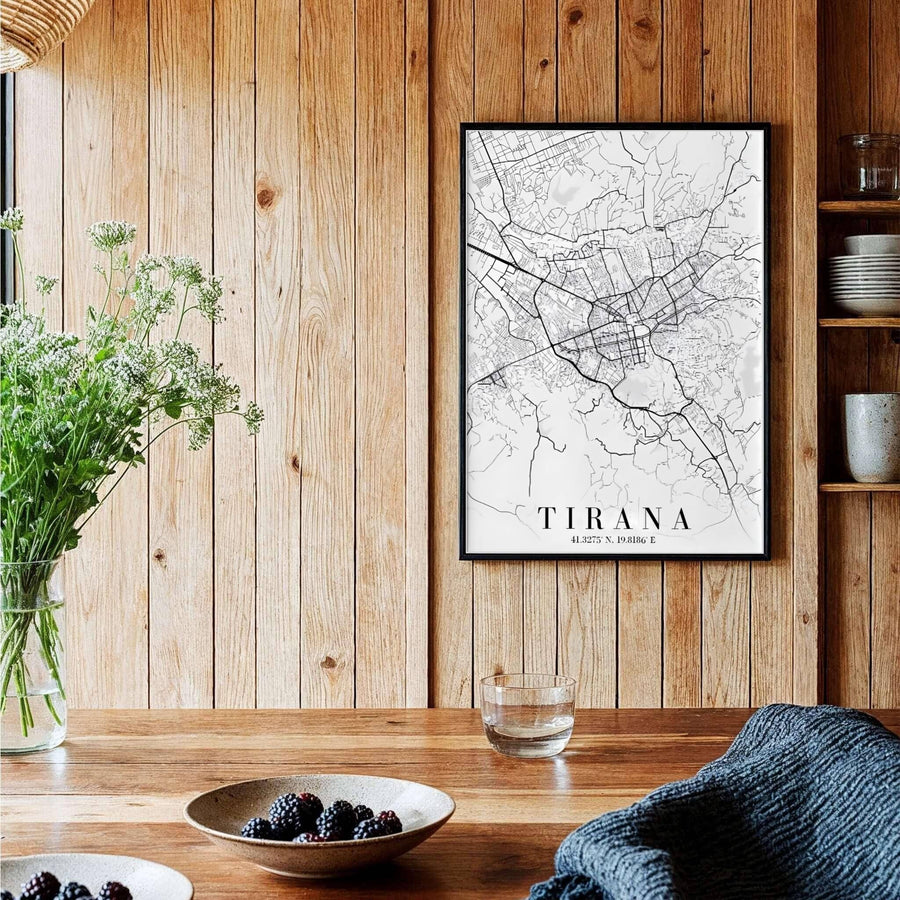 A sophisticated black and white geographical map of Tirana, Albania, framed by clean borders in a vertical portrait format. Available across multiple formats including unframed paper, tailored wooden frames, and gallery-wrapped canvas options.