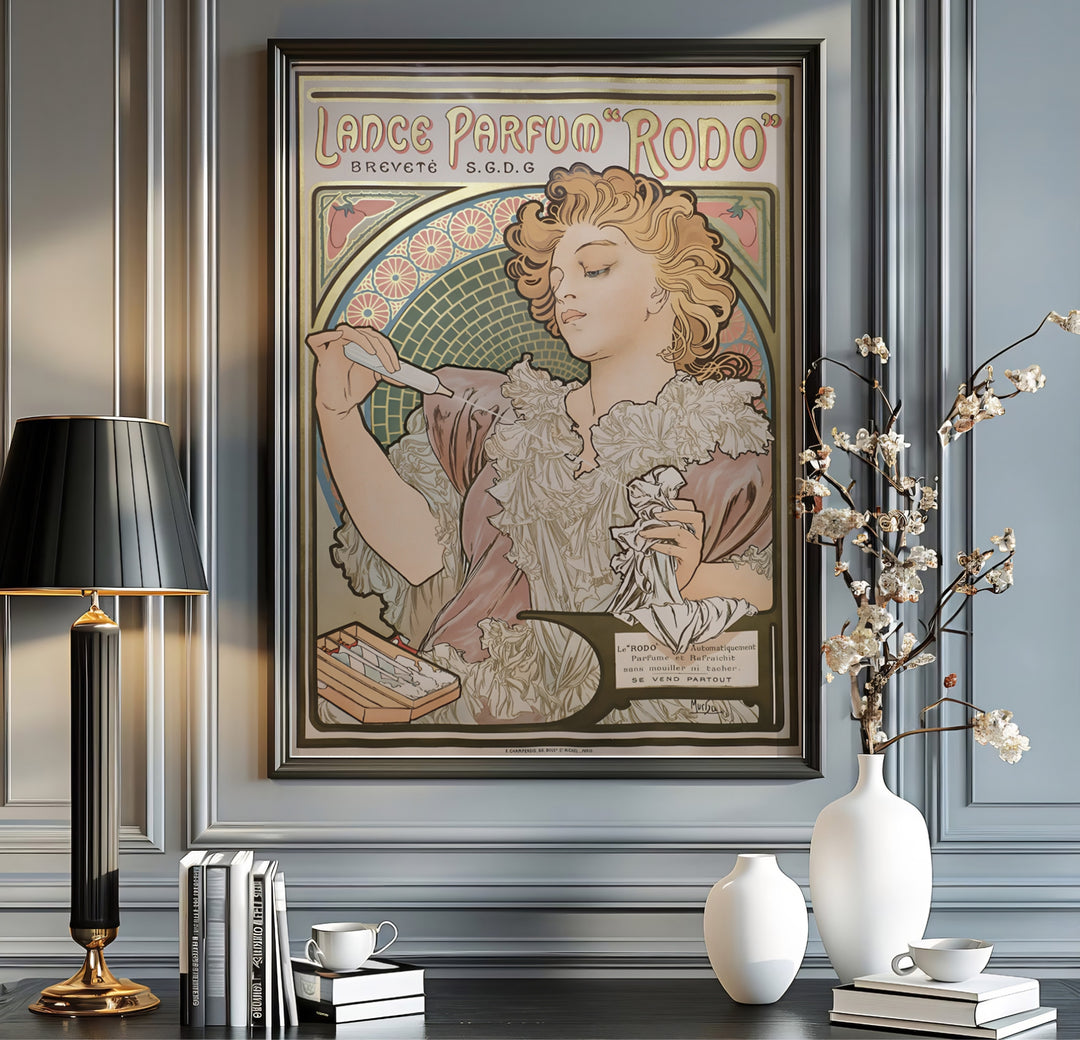 Vintage Parisian advertisement poster Lance Parfum Rodo by artist Alphonse Mucha displaying rose pink and olive green hues in Paris France. Shop high-definition framed, unframed, and canvas art print choices at MapYourDreams.