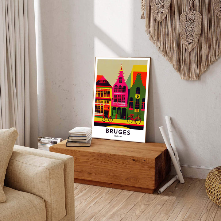 A modern travel poster depicting bright pink and green townhouses with bicycles in Bruges, Belgium, finished with crisp text reading Bruges Belgium. Available across multiple options including unframed art paper, custom framed poster styles, and gallery canvas wall displays.