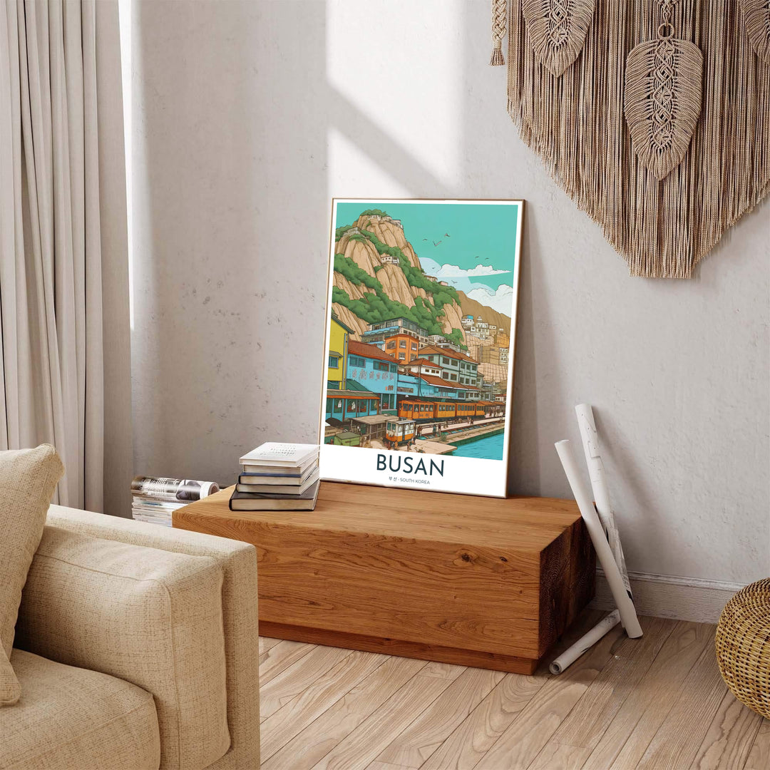 Colorful Asian travel poster of Busan, South Korea, displaying a coastal harbor train route flanked by powder blue, teal, and yellow seaside buildings. Offered by MapYourDreams, this artwork is available in flexible options including unframed paper, custom wooden frames, and gallery canvas wraps.