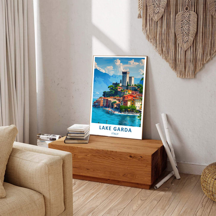 A bright travel graphic of Lake Garda in Northern Italy showcasing the village of Malcesine, filled with colorful pastel houses, blue water, and a towering stone castle; customized to fit your interior space as an unframed poster, premium canvas print, or framed wall display.