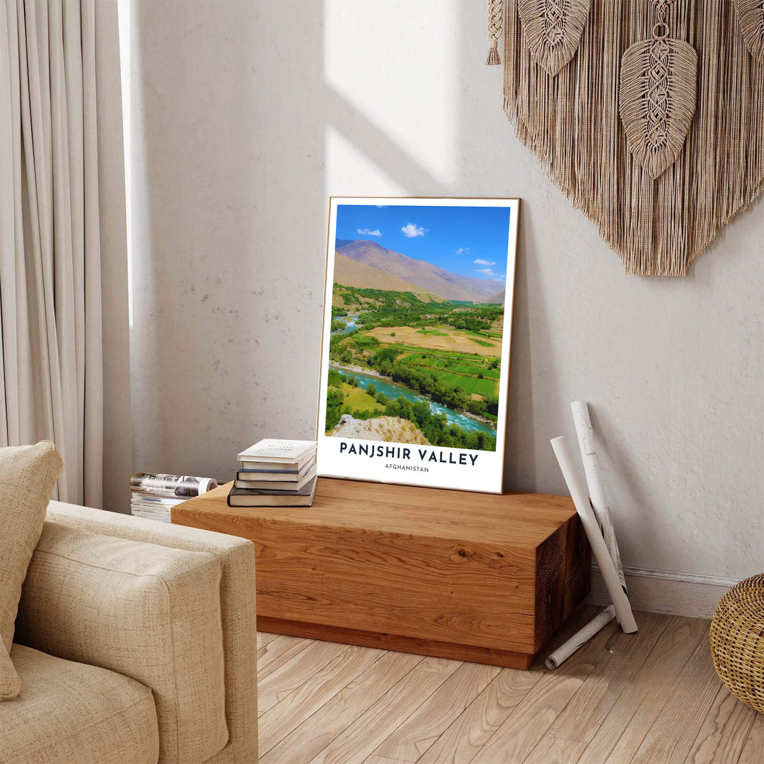 Nature-inspired poster of Panjshir Valley, Afghanistan, depicting green riverbank trees and sweeping mountain hills under a soft blue sky. Crafted by MapYourDreams as an unframed poster, a gallery-wrapped canvas print, or a custom framed print in retro black and retro white frames for cozy living room spaces.