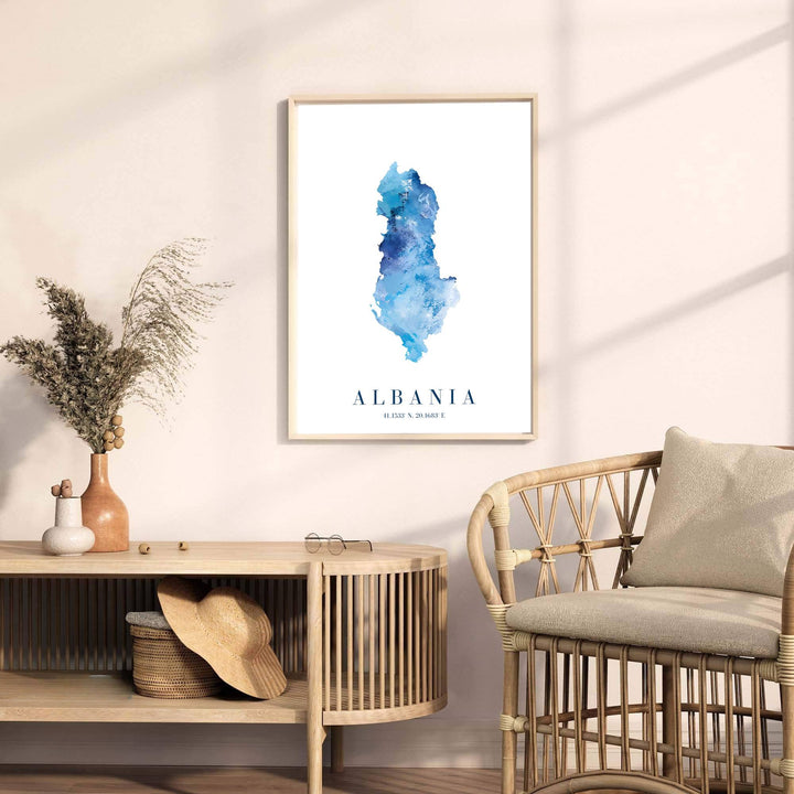 Minimalist Albania country map poster rendered in soft cobalt watercolor tones with clear coordinates listed beneath the prominent serif country title. Offered by MapYourDreams, this artwork is available in flexible options including unframed paper, custom wooden frames, and gallery canvas wraps for room decor.