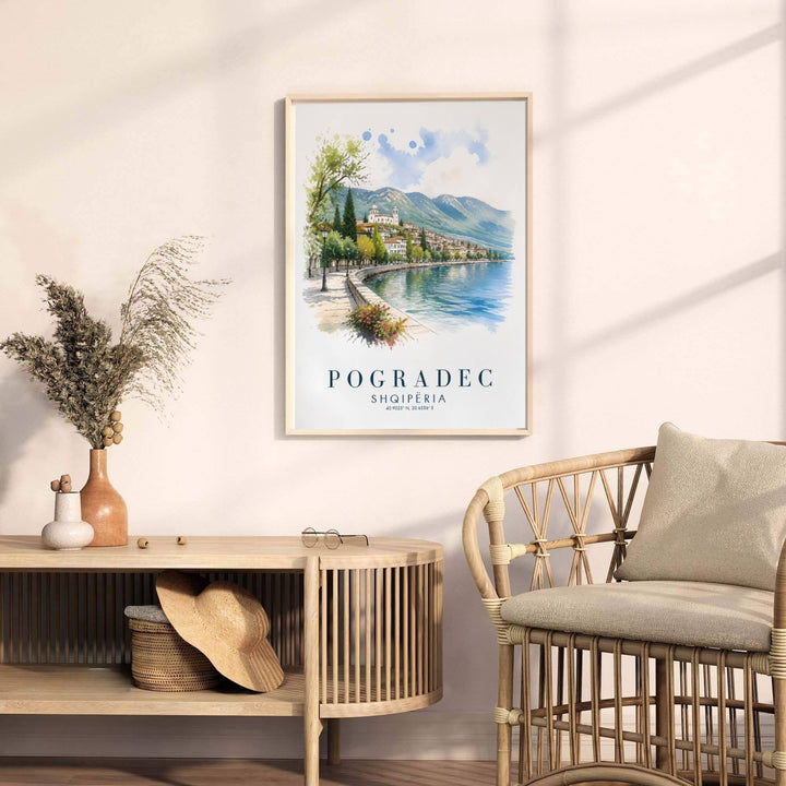 Looking past blooming garden planters toward rolling green hills, this Pogradec art print celebrates Albanian lakeside heritage and summer views. Select your preferred format, such as unframed fine art paper, a custom wood frame, or a gallery canvas wrap.