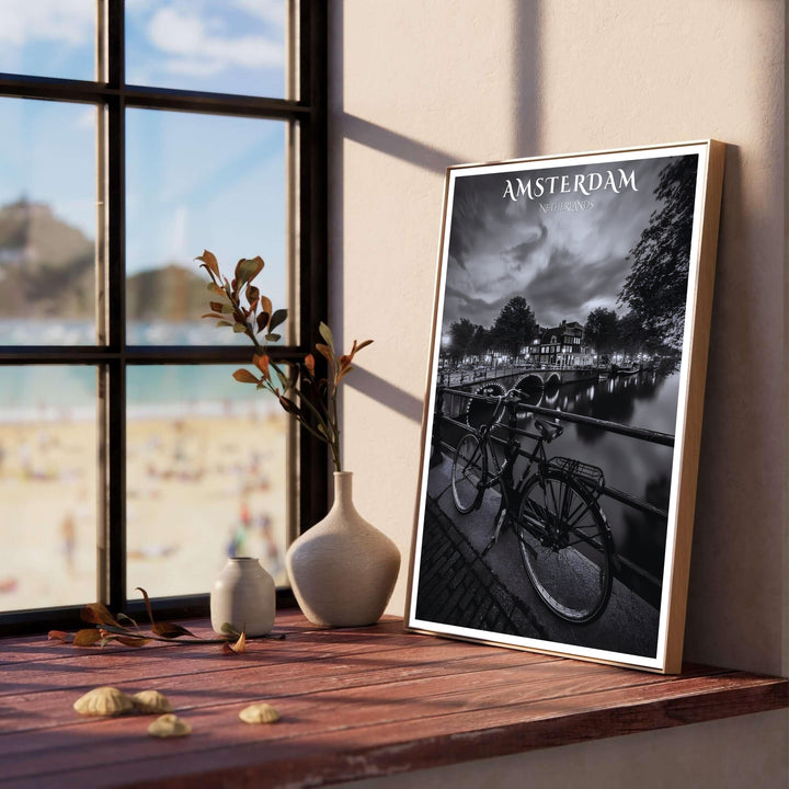 Detailed nocturnal photography print showing canal reflections, historic gabled houses, and a bicycle in Amsterdam Netherlands, provided by MapYourDreams with choices spanning unframed art prints, stretched canvas decor, and custom frame choices in black, white, and natural wood finishes.
