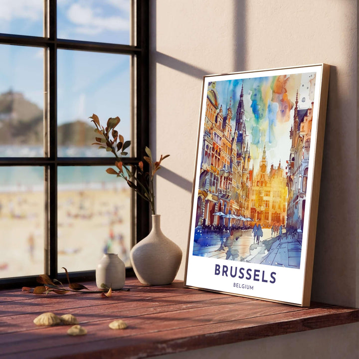 High-resolution watercolor print of Brussels Grand Place in Belgium, featuring cobalt blue skies, golden architectural highlights, and crisp bottom typography. Customers can choose from several presentation options including unframed fine art paper, custom wood and metal frames, and gallery wrapped canvas wall decor.