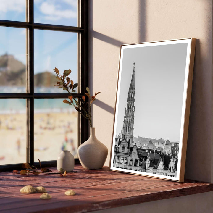 High-resolution black and white photograph of the Brussels Town Hall tower in Belgium showcasing fine architectural details and subtle tones. Customers can choose from several presentation options including unframed fine art paper, custom wood and metal frames, and gallery wrapped canvas wall decor.