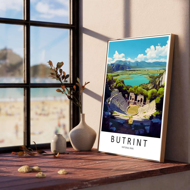 Capturing the iconic Butrint amphitheater and arched stage ruins set against coastal wetlands and blue skies, this fine art poster decorates walls. Offered by MapYourDreams, this artwork is available in flexible options including unframed paper, custom wooden frames, and gallery canvas wraps.