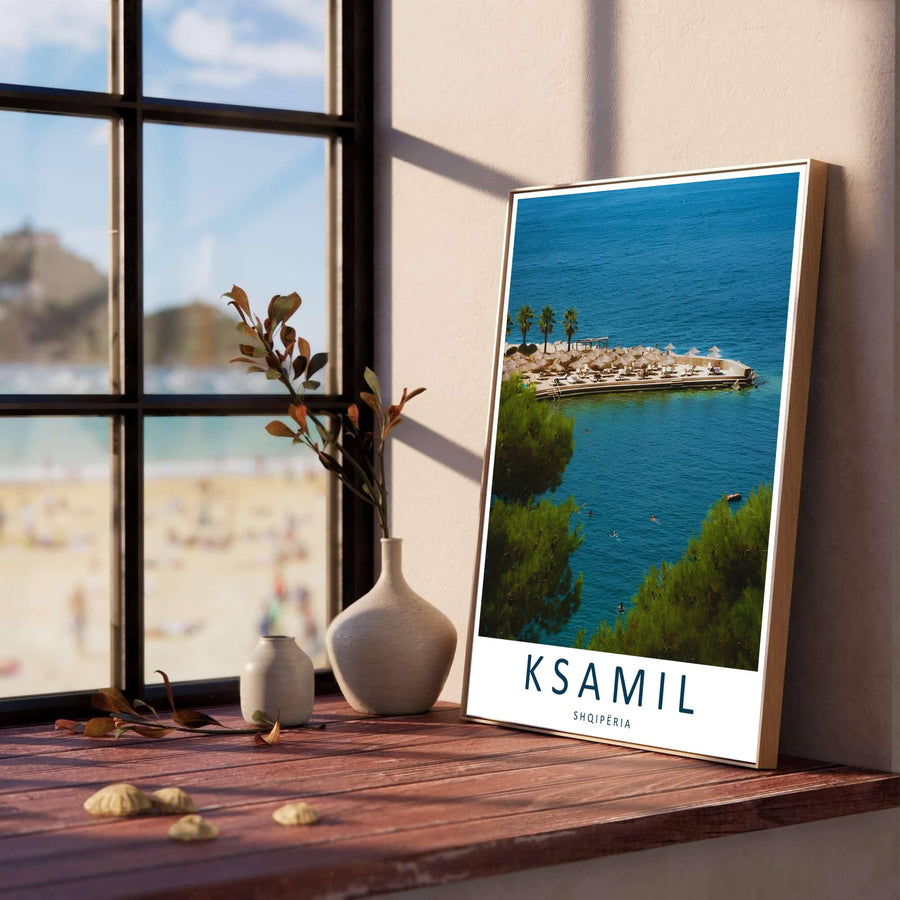 Thatched umbrellas and sun loungers rest on a concrete pier overlooking the deep blue sea in Ksamil, creating a classic European travel poster. Offered in versatile formats including unframed art paper, custom wood framing, and stretched canvas wraps to elevate your space.
