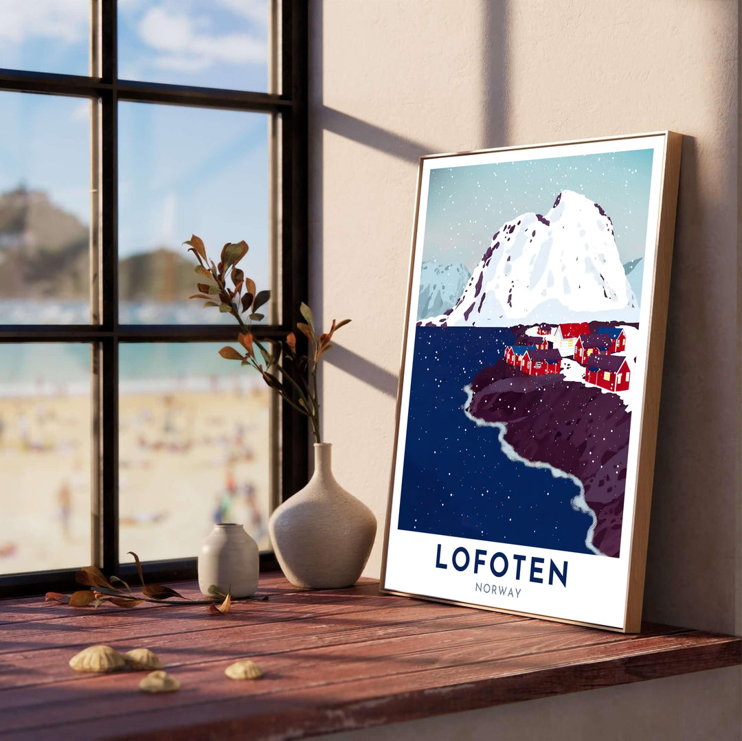 Graphic winter art print of Lofoten Norway showing a quiet snowy village along a dark coastline with steep alpine peaks in the background. Upgrade your room layout with this travel decor piece, available in custom wood framed styles, gallery quality stretched canvas panels, and unframed poster paper options.