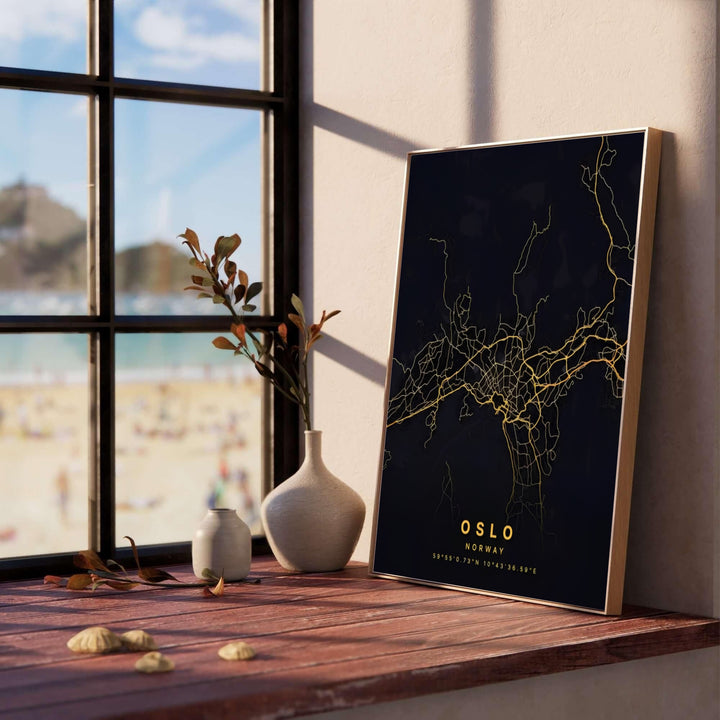 Luxury cartographic print featuring the capital city grid of Oslo Norway in metallic gold tones over a pitch-black background. Created by MapYourDreams, this modern map artwork is offered as an unframed fine art paper print, custom wooden framed setup, or floating canvas wall display.