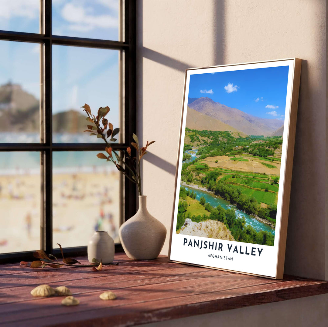 Natural scenery poster of Panjshir Valley, Afghanistan, highlighting the glistening Panjshir River winding through vibrant green farmland below tall brown mountains. Offered by MapYourDreams as an unframed fine art print, a stretched gallery canvas, or a framed wall poster with a retro black or natural frame finish.