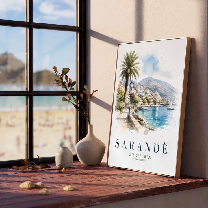 Soft blue and cerulean watercolor washes illustrate the serene Ionian bay of Sarandë, creating a classic European travel poster for living rooms or bedrooms. Offered in versatile formats including unframed art paper, custom wood framing, and stretched canvas wraps to elevate your space.
