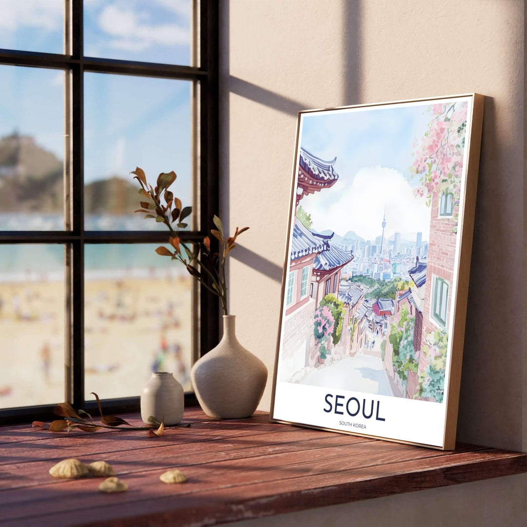 Delicate watercolor landscape poster presenting a charming side street in Seoul, South Korea, lined with historic Korean wooden gates, brick facades, blooming flowers, and N Seoul Tower in misty blue hues. Offered by MapYourDreams, this artwork is available in flexible options including unframed paper, custom wooden frames, and gallery canvas wraps.