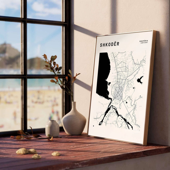 Intricate road lines and prominent black lake silhouettes form an artistic abstract map of Shkodër, Albania, perfect for modern offices or living rooms. Offered in versatile formats, including unframed art paper, custom wood framing, and stretched canvas wraps to elevate your space.