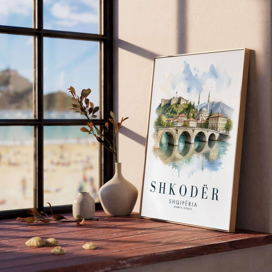 Soft blue and warm stone watercolor washes illustrate the serene river landscape of Shkodër, creating a classic European watercolor travel poster for living rooms or bedrooms. Offered in versatile formats including unframed art paper, custom wood framing, and stretched canvas wraps to elevate your space.