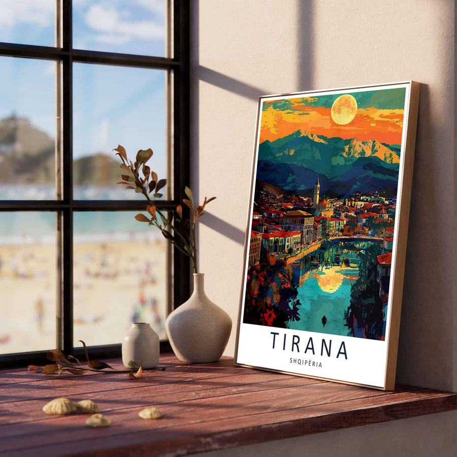 Fiery orange and golden hues illuminate the mountain peaks above Tirana, creating a classic European sunset travel poster for modern living rooms. Offered in versatile formats including unframed art paper, custom wood framing, and stretched canvas wraps to elevate your space.